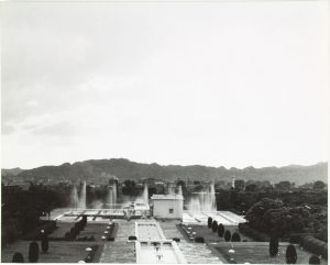 a small, square structure set in a pool curtained by fountains