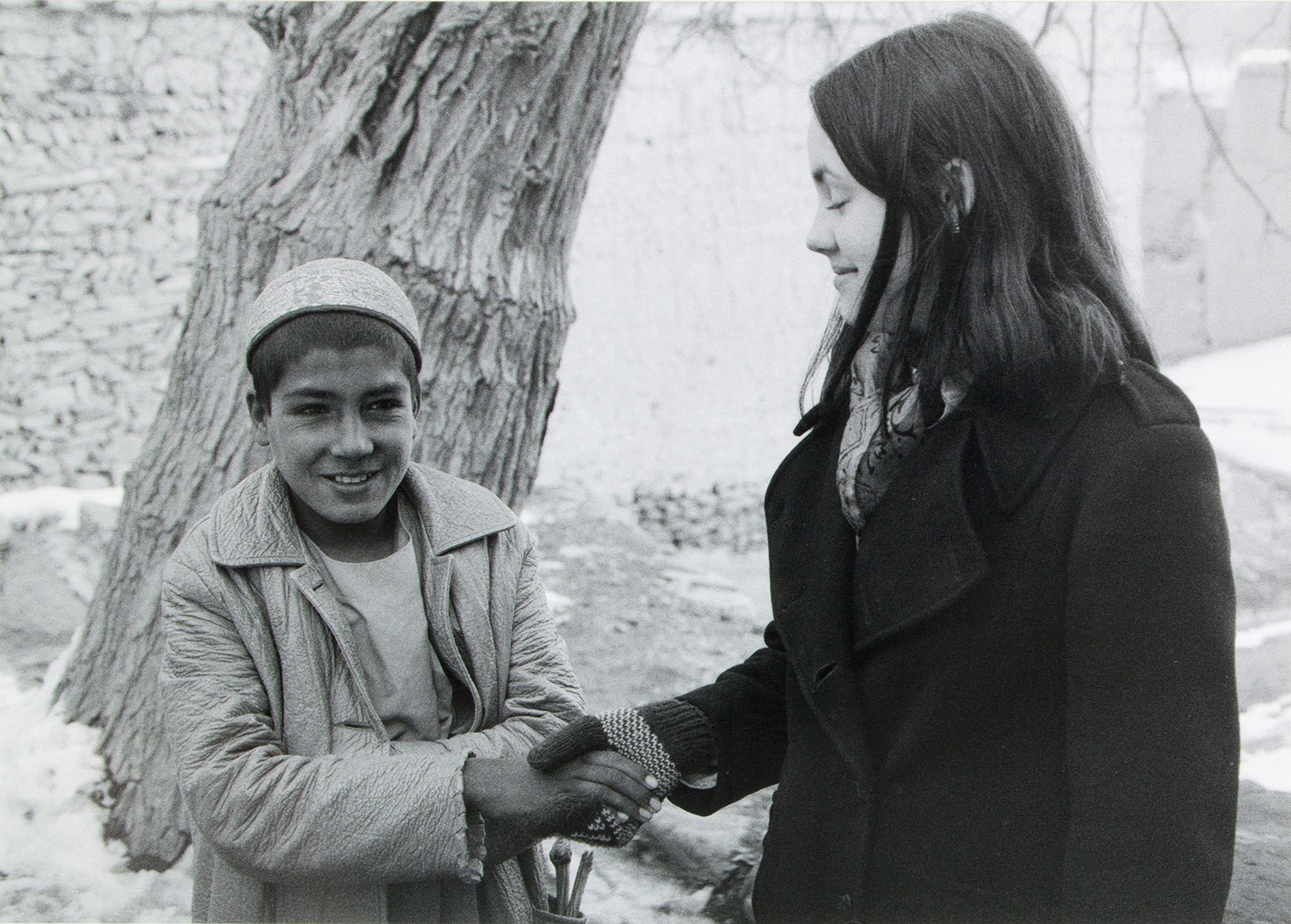 a child and a woman shaking hands