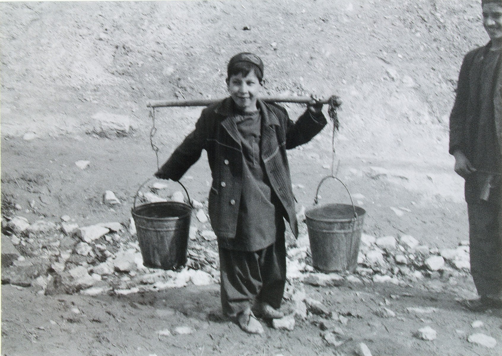 child carrying water buckets