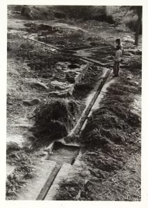 a narrow watercourse, carved into the surface of the rock, linking a series of pools and water chutes