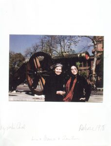 photograph of a two women in front of a canon