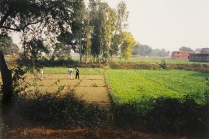 photograph of three people in a field