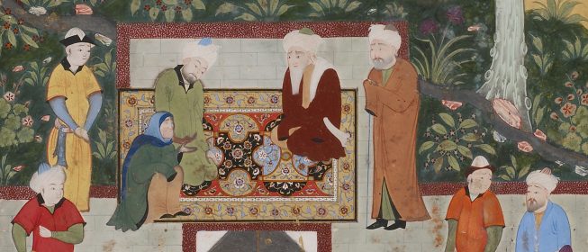 A woman and two men gathered in a garden, kneeling on a rug