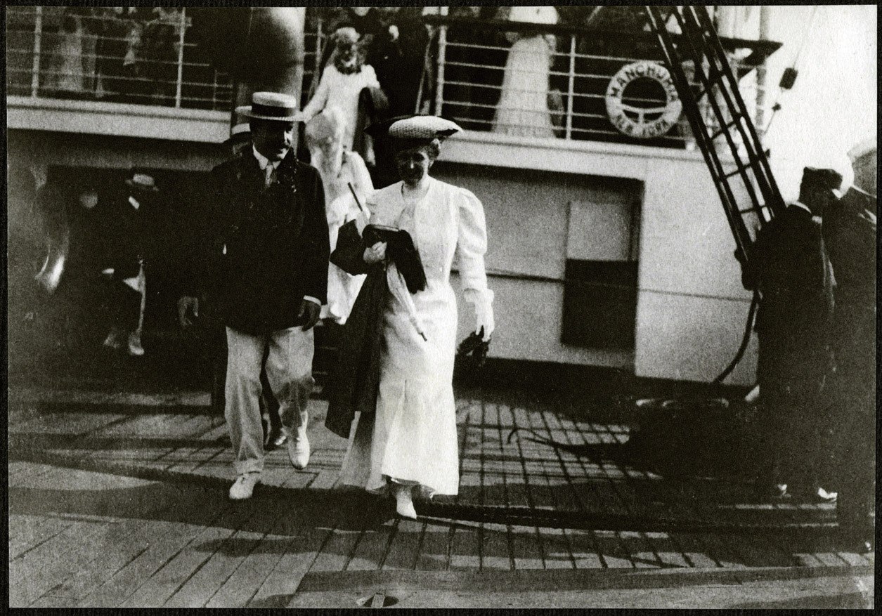 Nicholas Longworth and unidentified woman walking on deck of the SS Manchuria upon arrival in Hawaii.