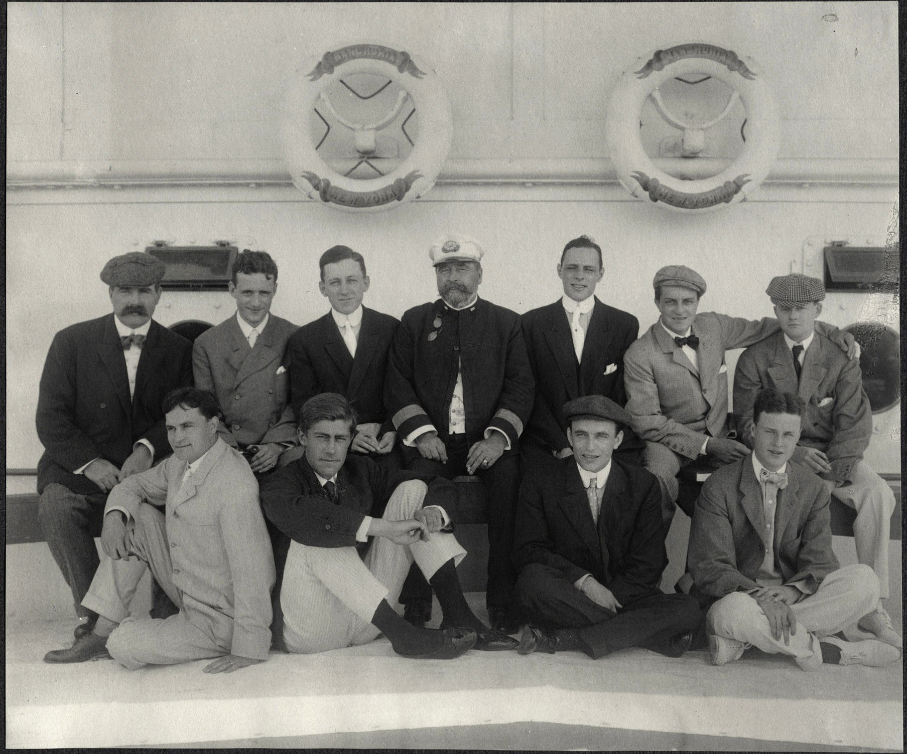 A group photograph of Harvard alumni passengers aboard the SS Manchuria including Nicholas Longworth and Capt. J. W. Saunders.