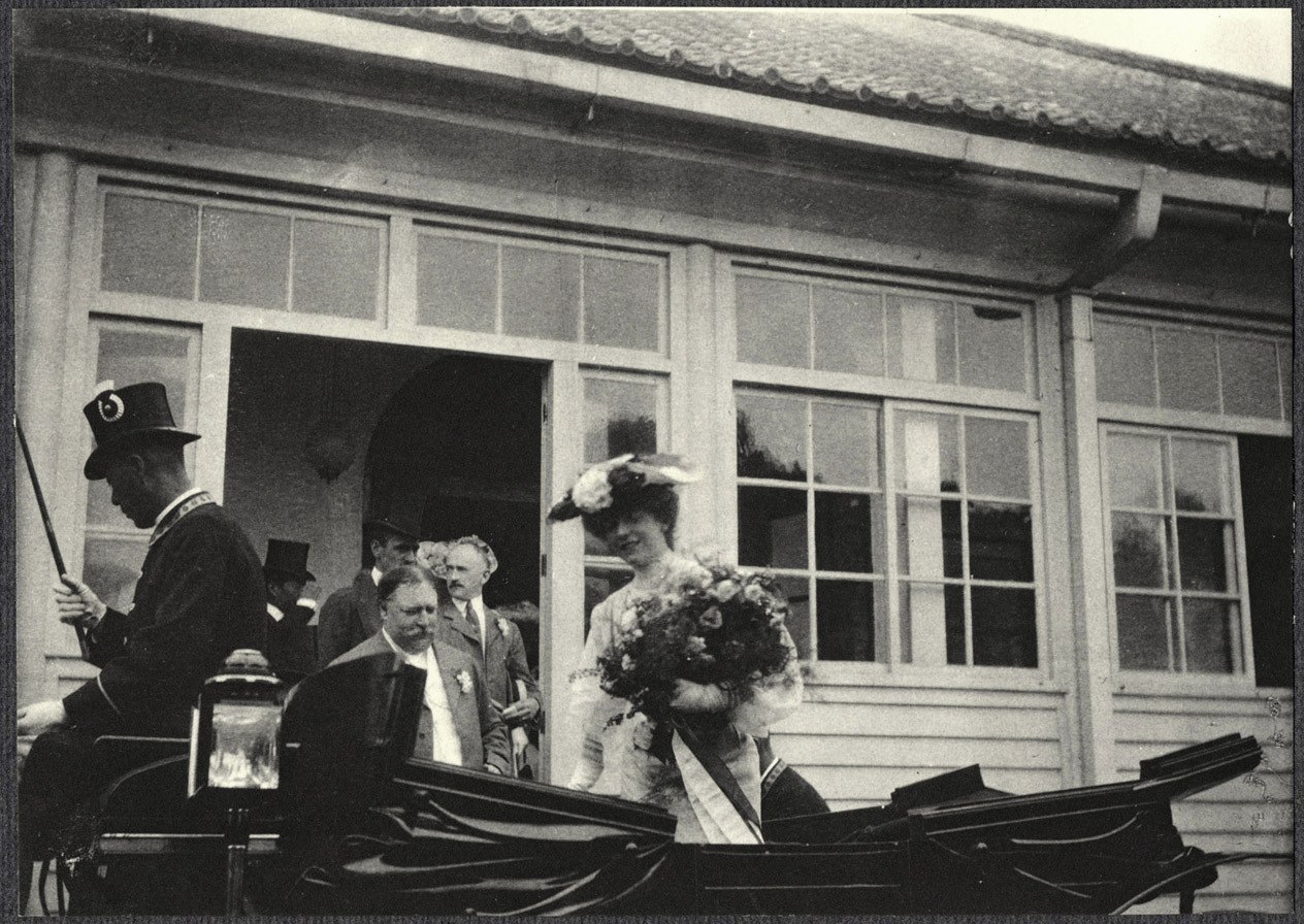 Yokohama: Alice Roosevelt standing in carriage with a bouquet at Imperial villa