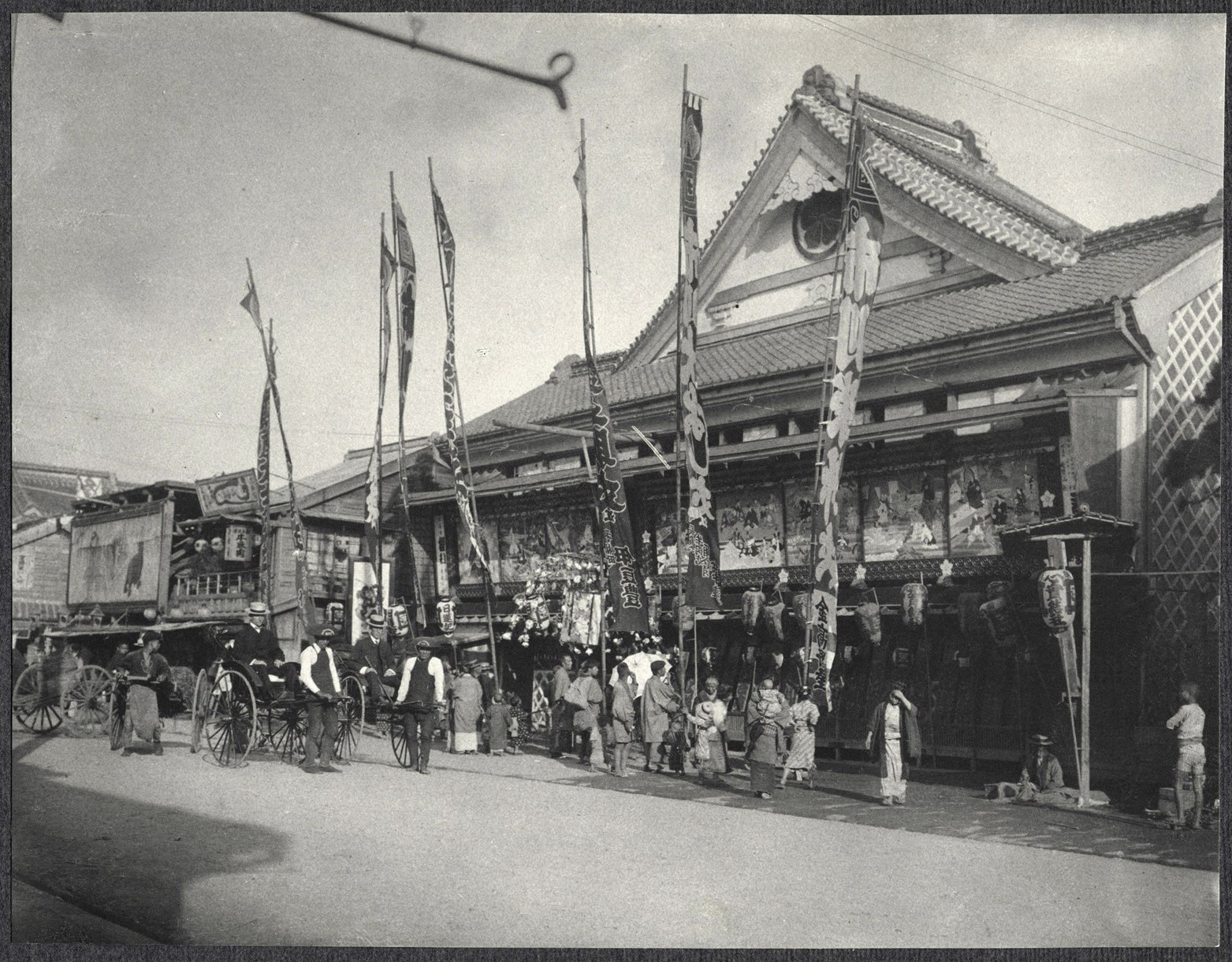 Tokyo: American men in rickshaws in front of a Theatre