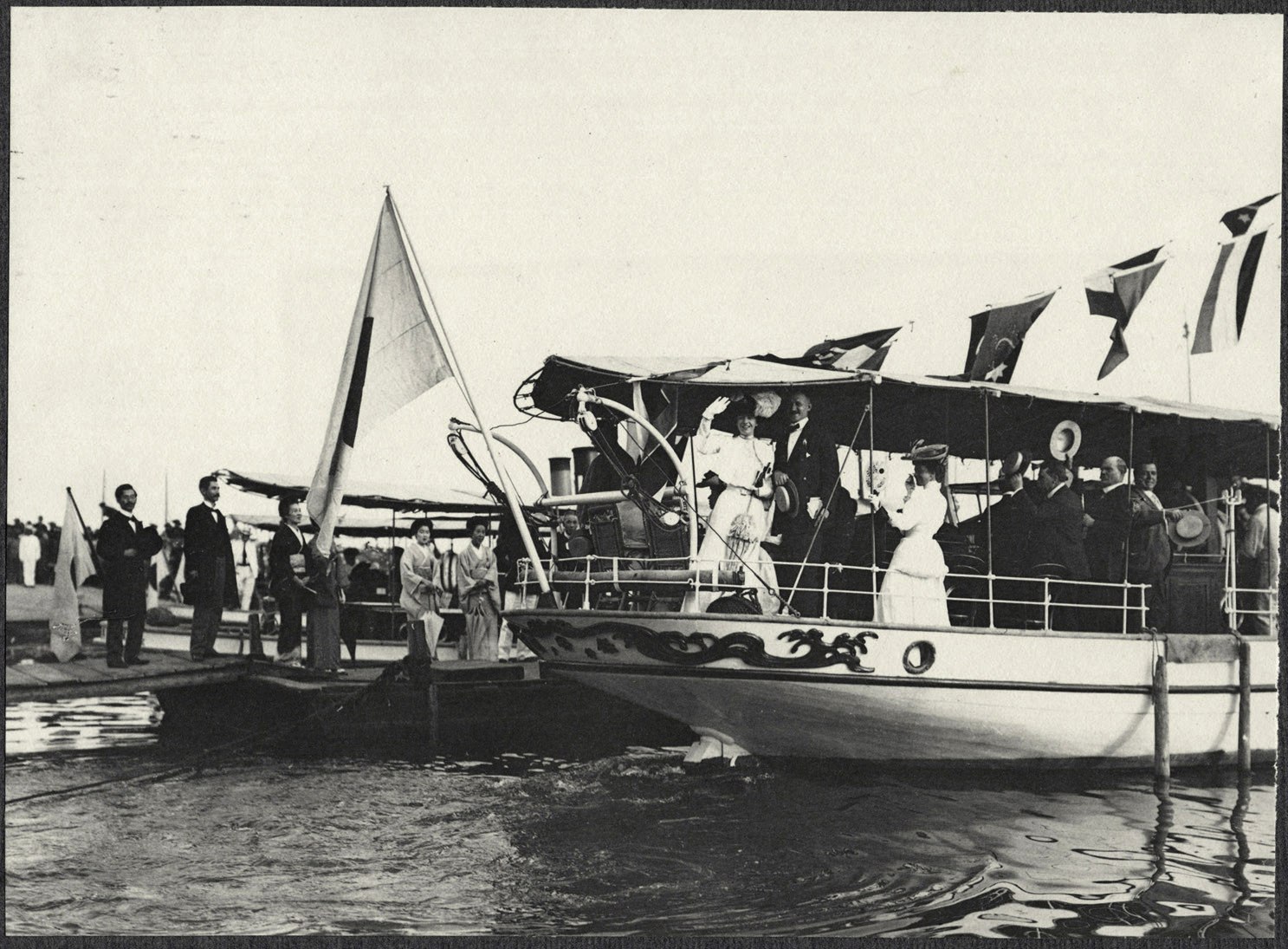 Alice Roosevelt and others wave from launch at Kobe port en route to S.S Manchuria