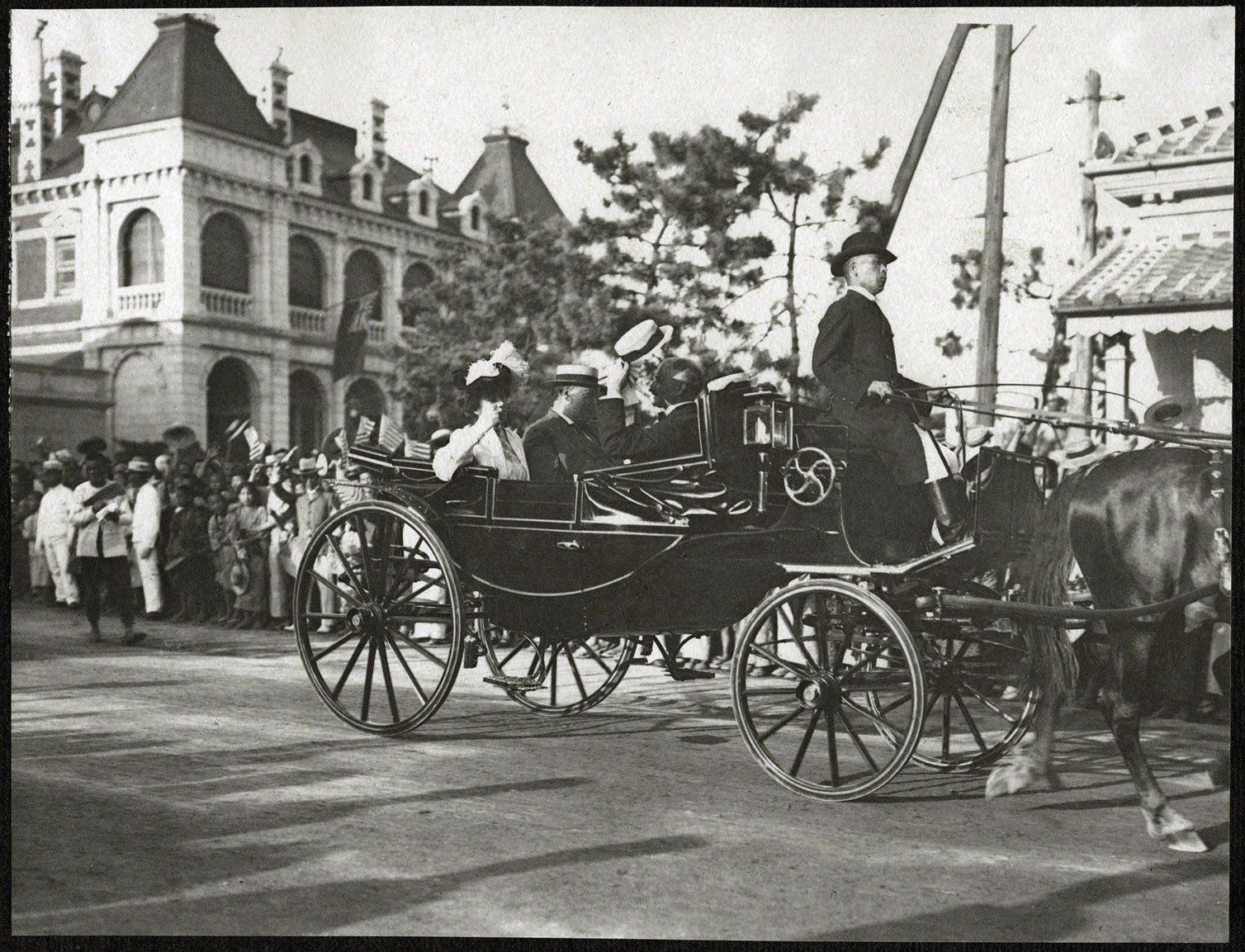 Kobe: William H. Taft and Alice Roosevelt passing cheering crowds on the Bund