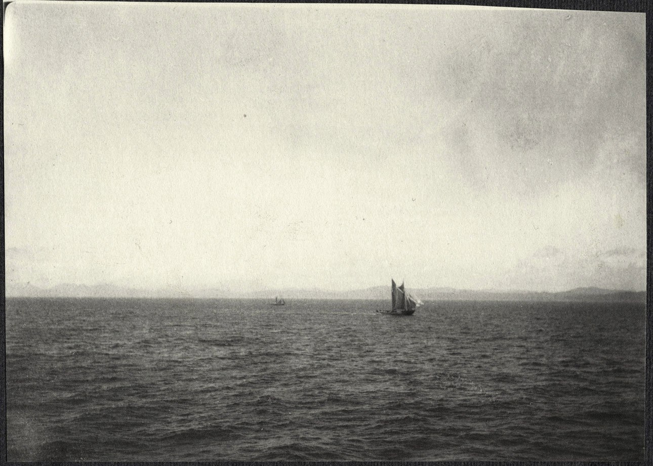 Distant sailboats off the coast of Japan