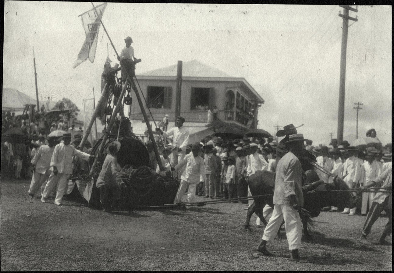 Iloilo City: Parade of an oxen pulled skid, perhaps with an iron boiler