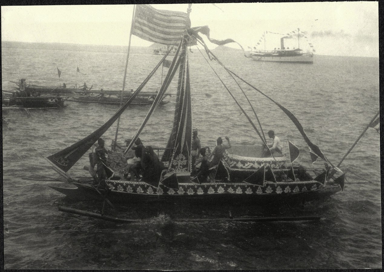 Zamboanga: decorated banca with American flag, from the deck of the USS Logan