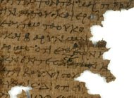 A dark brown papyrus codex, very old and in pieces.