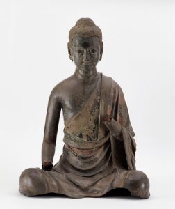 A seated buddha; the hands are missing
