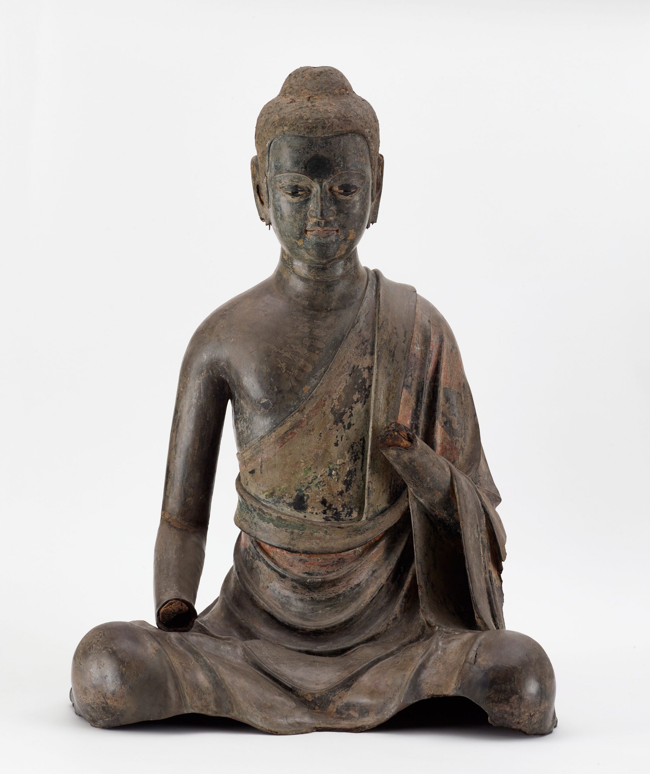 A seated buddha; the hands are missing