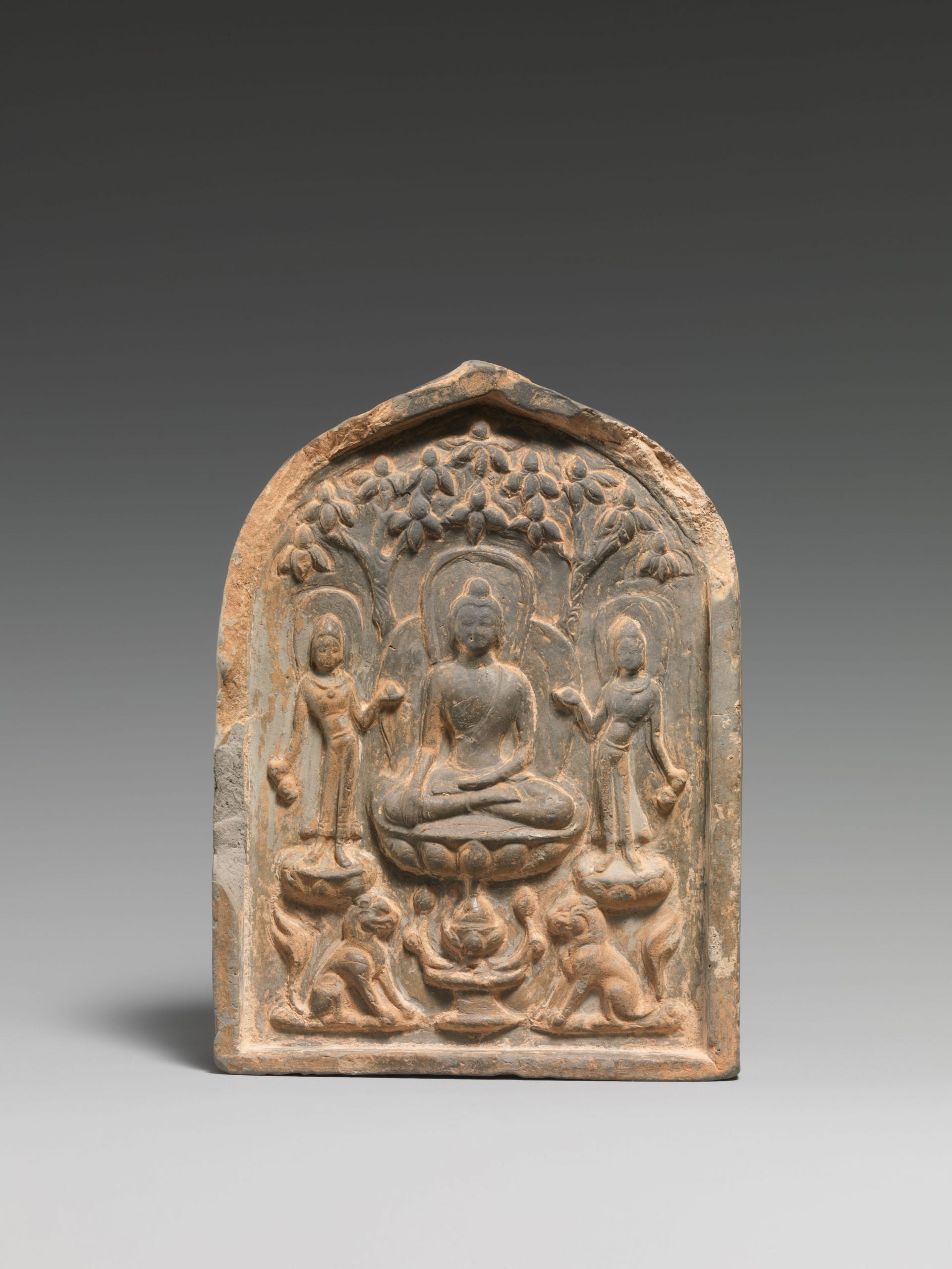 A stone plaque, arched on top