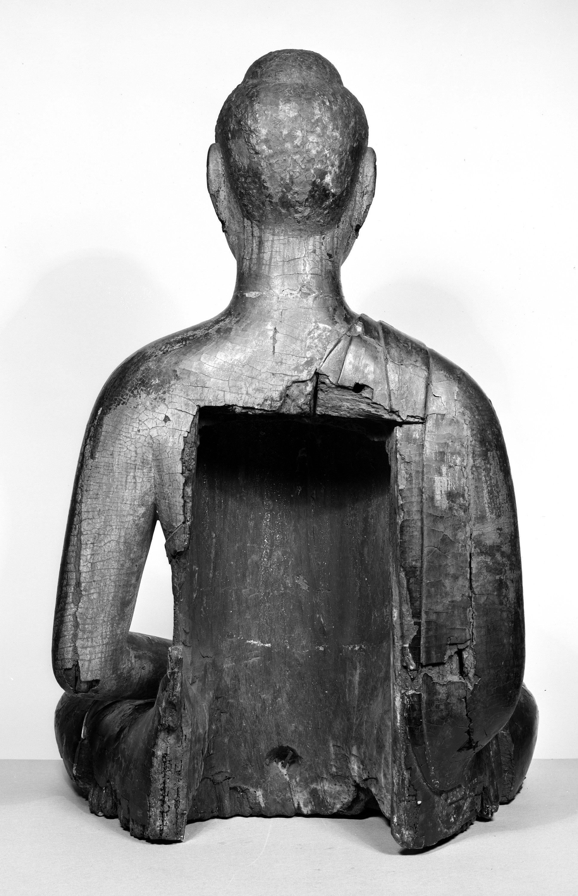 Back of Walters buddha sculpture with a squarish hole in the back