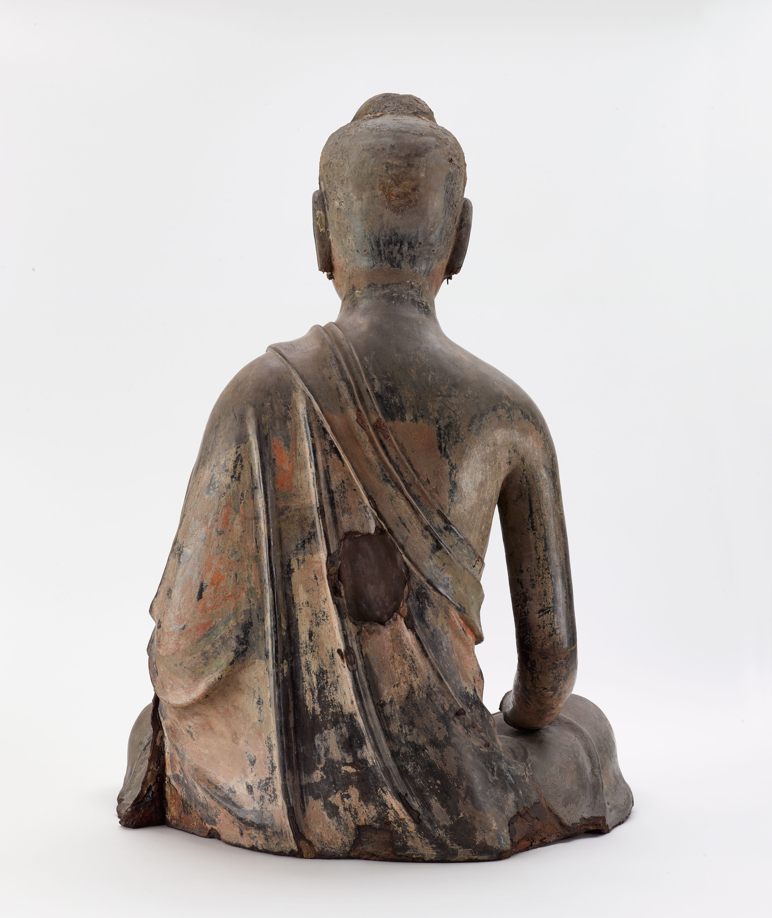 back of seated buddha sculpture