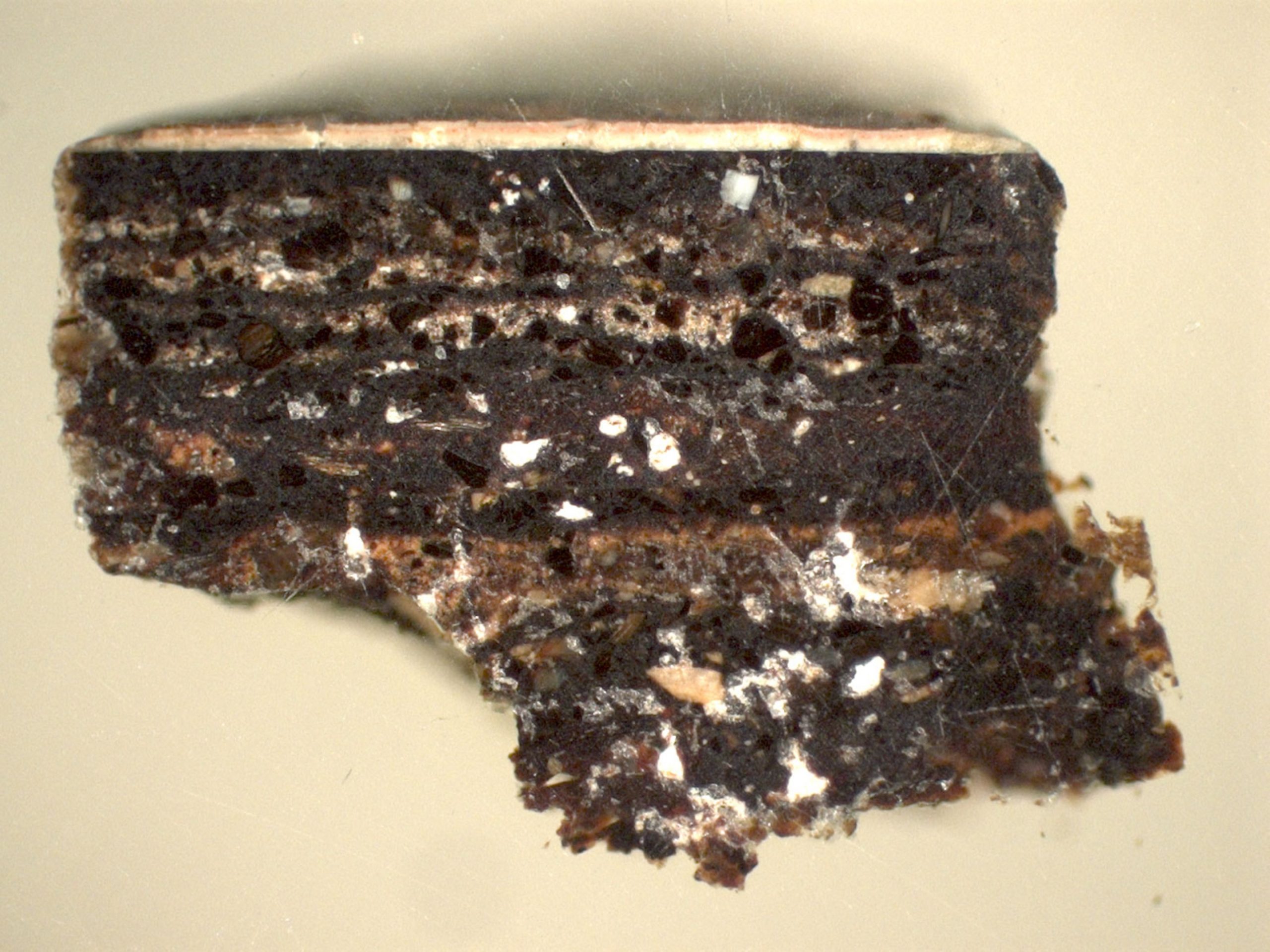 A magnified cross section of the layers of lacquer and textile resembling chocolate cake.