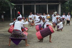 Gendang beleq performers outside, beating on huge, colorful drums.