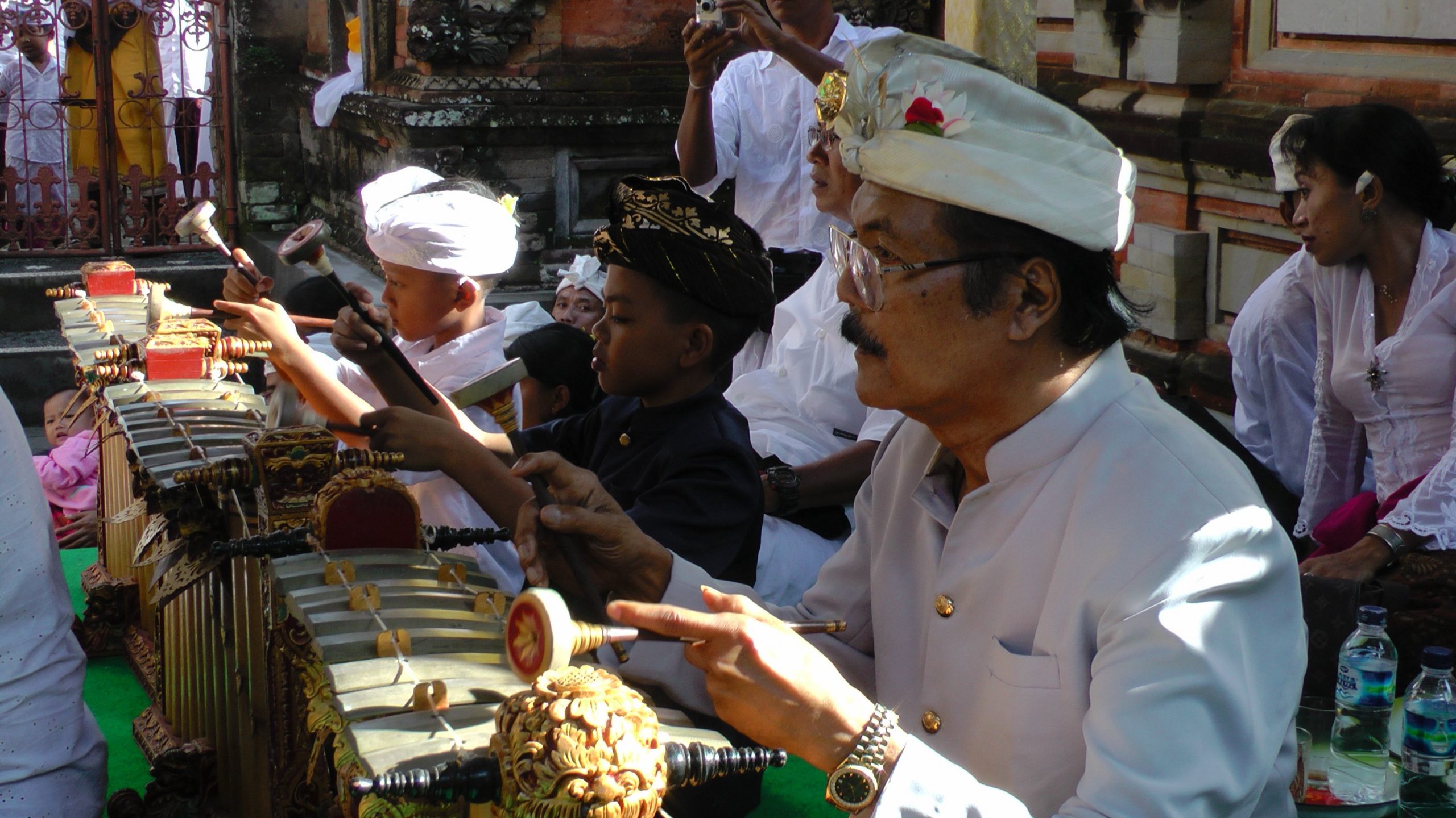 A man and his students playing gamelan.