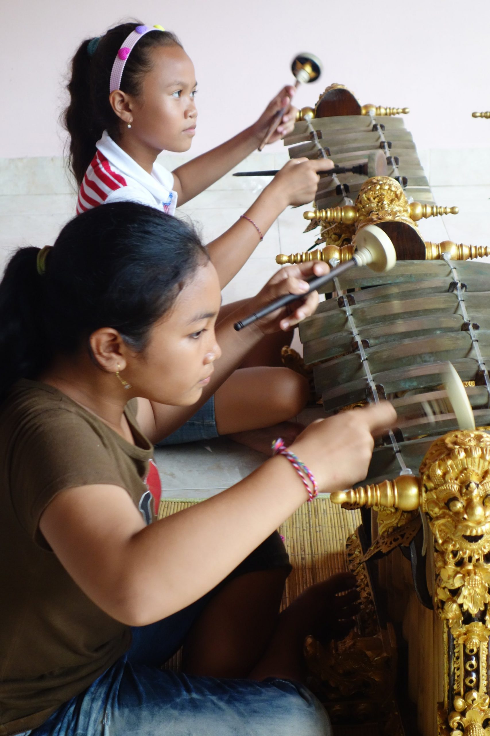 Close-up of two girls playing gender, in profile.