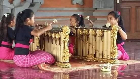 Four girls in pink and black outfits playing gender.