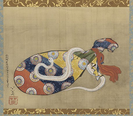 A white snake slithers around a lute wrapped in red, blue, yellow and green patterned back.