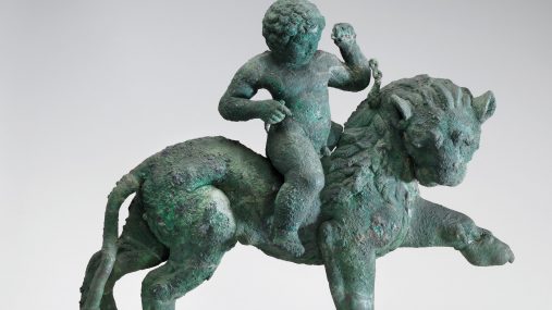 detail from a bronze sculpture of a young boy riding a horse