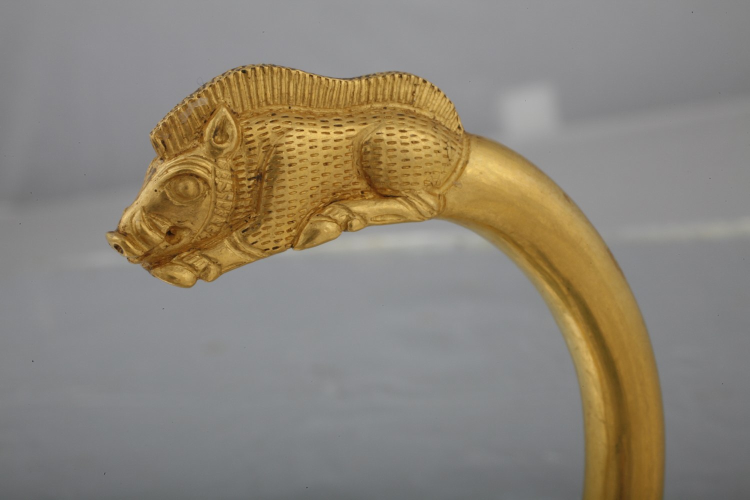 gold bracelet features a boar were commonly hunted in ancient times. Careful attention was paid to the hair and bristles of the recumbent boars that serve as the terminals of these gold bracelets.