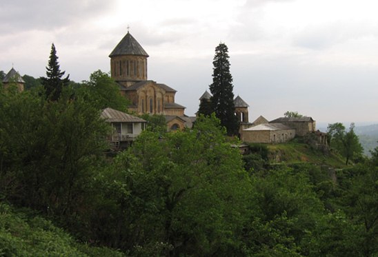 green lush trees with the Gelati Monastery complex in the background