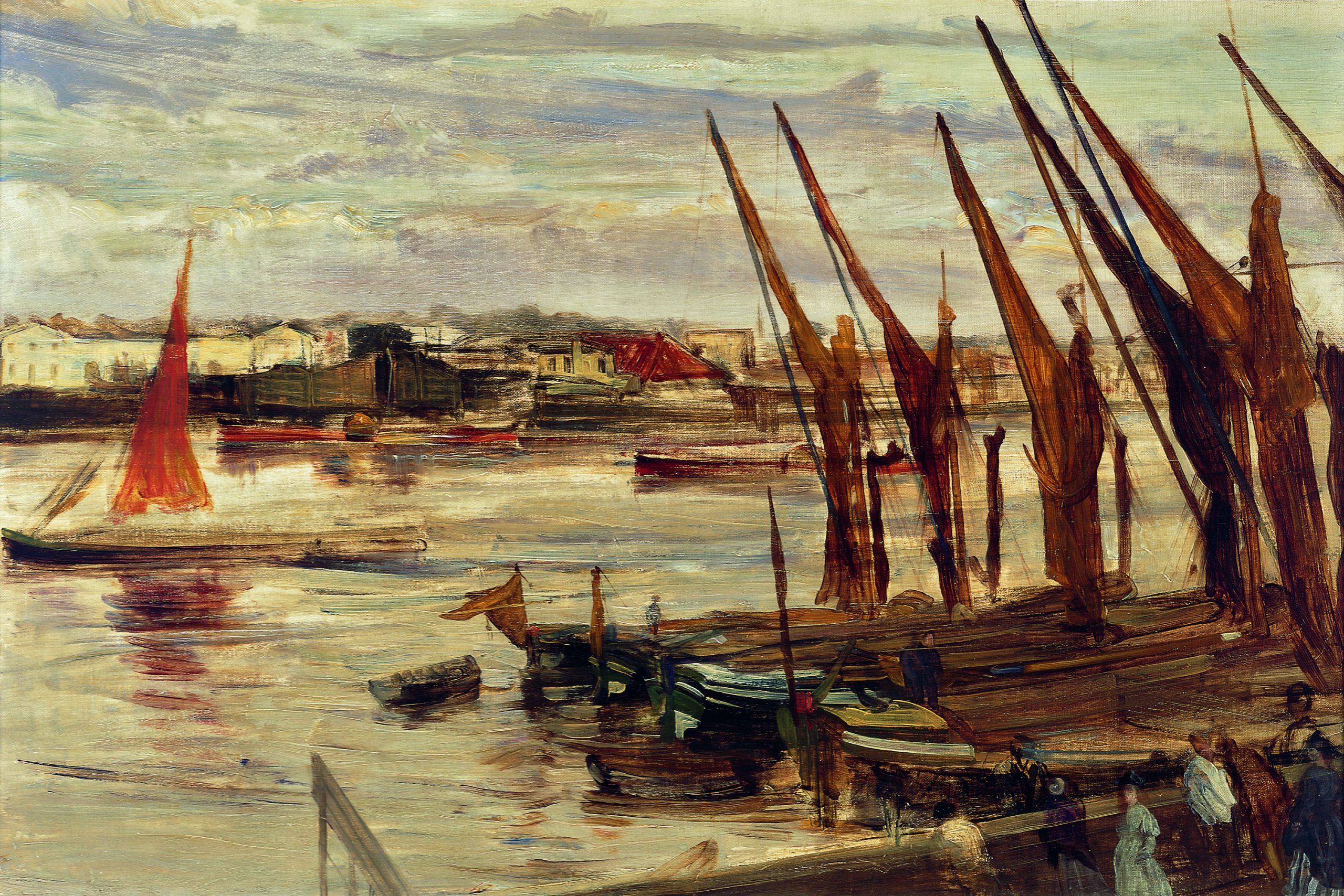 wooden boats lined up along a river bank with buildings in the background.