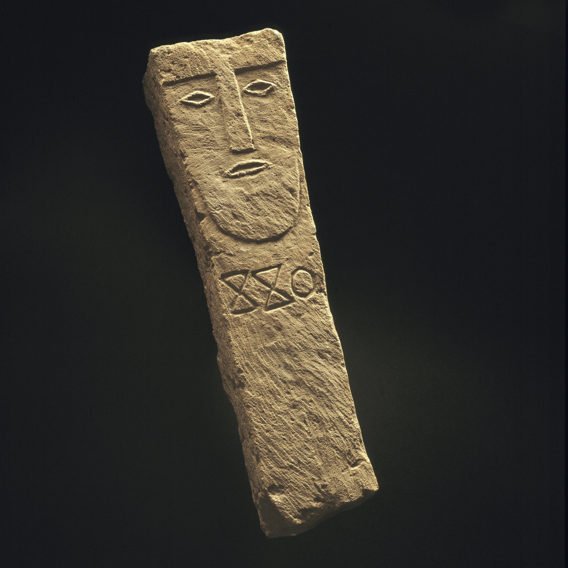Limestone funerary pillar stela