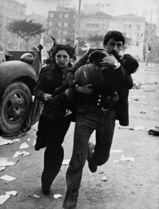 photo of a family running down a war-torn street