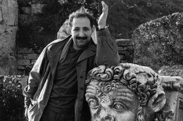 detail, a photo of Ara Güler standing next to a sculpture of a head