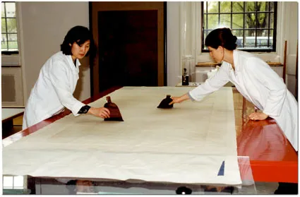Two conservators at work