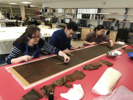 three conservators working