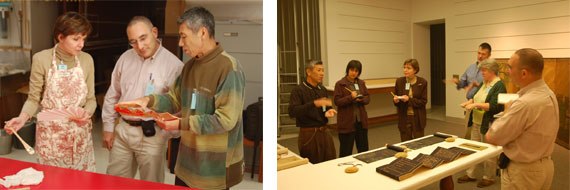 Visiting conservators and art historians examine paintings