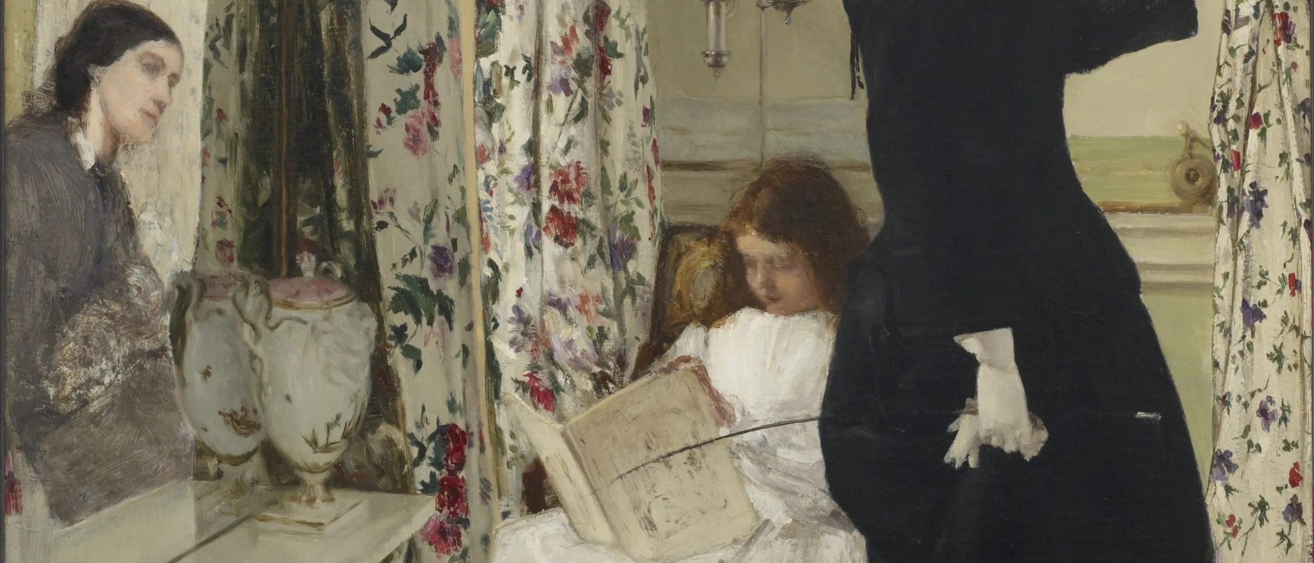 A girl in a white dress and a woman in a black dress amidst floral curtains.